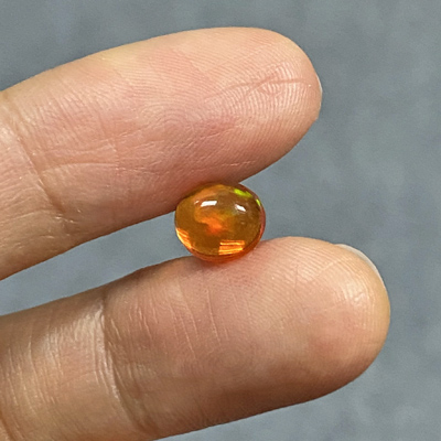 โอปอลไฟ (Fire Opal) จากเม็กซิโก 1.19 กะรัต สีส้ม มีเหลือบสีเขียว