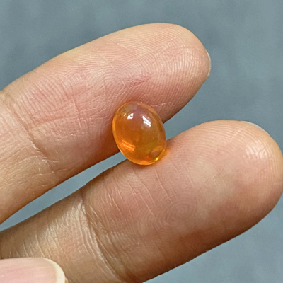 โอปอลไฟ (Fire Opal) จากเม็กซิโก 0.98 กะรัต สีส้ม มีเหลือบไรๆ
