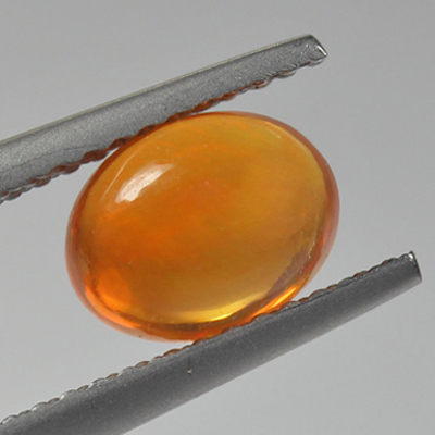 โอปอลไฟ (Fire Opal) จากเม็กซิโก 0.98 กะรัต สีส้ม มีเหลือบไรๆ