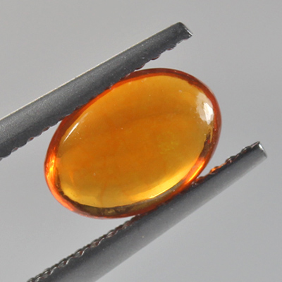 โอปอลไฟ (Fire Opal) จากเม็กซิโก 0.87 กะรัต สีส้ม มีเหลือบอ่อนๆ