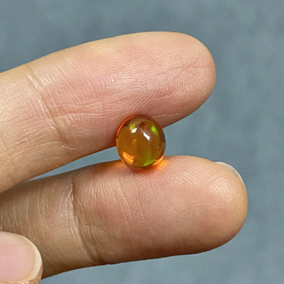 โอปอลไฟ (Fire Opal) จากเม็กซิโก 1.19 กะรัต สีส้ม มีเหลือบสีเขียว