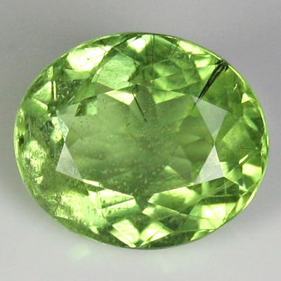 เพอริโด (Peridot) 7.39 กะรัต มีไหมสีดำ เม็ดใหญ่ หายาก จากปากีสถาน